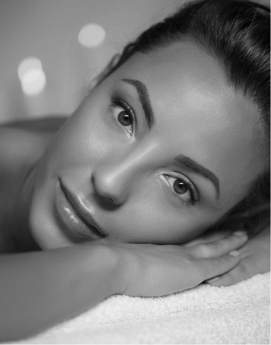 Picture of a women laying and smiling at the camera