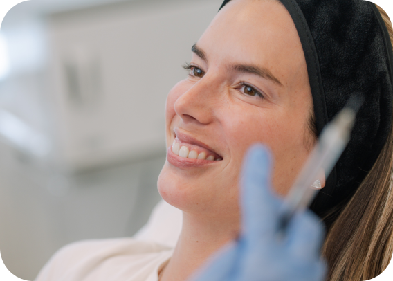 Woman smiling during a dermal filler procedure