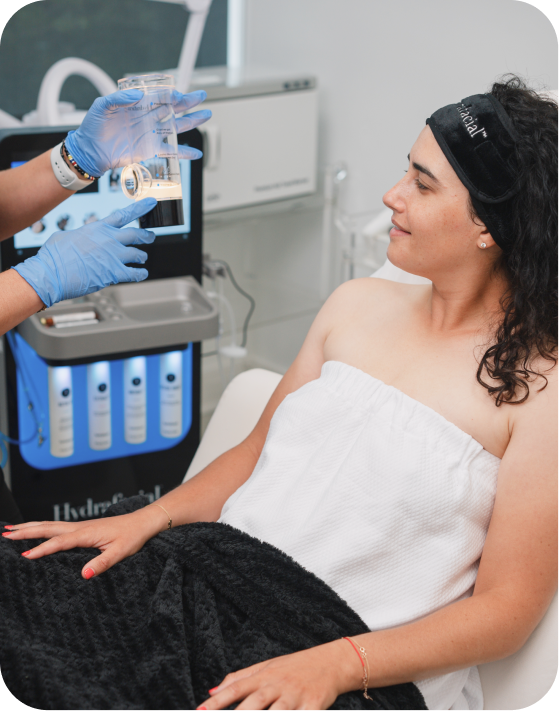 Picture of a women sitting on the bed ready for Hydrafacial Signature