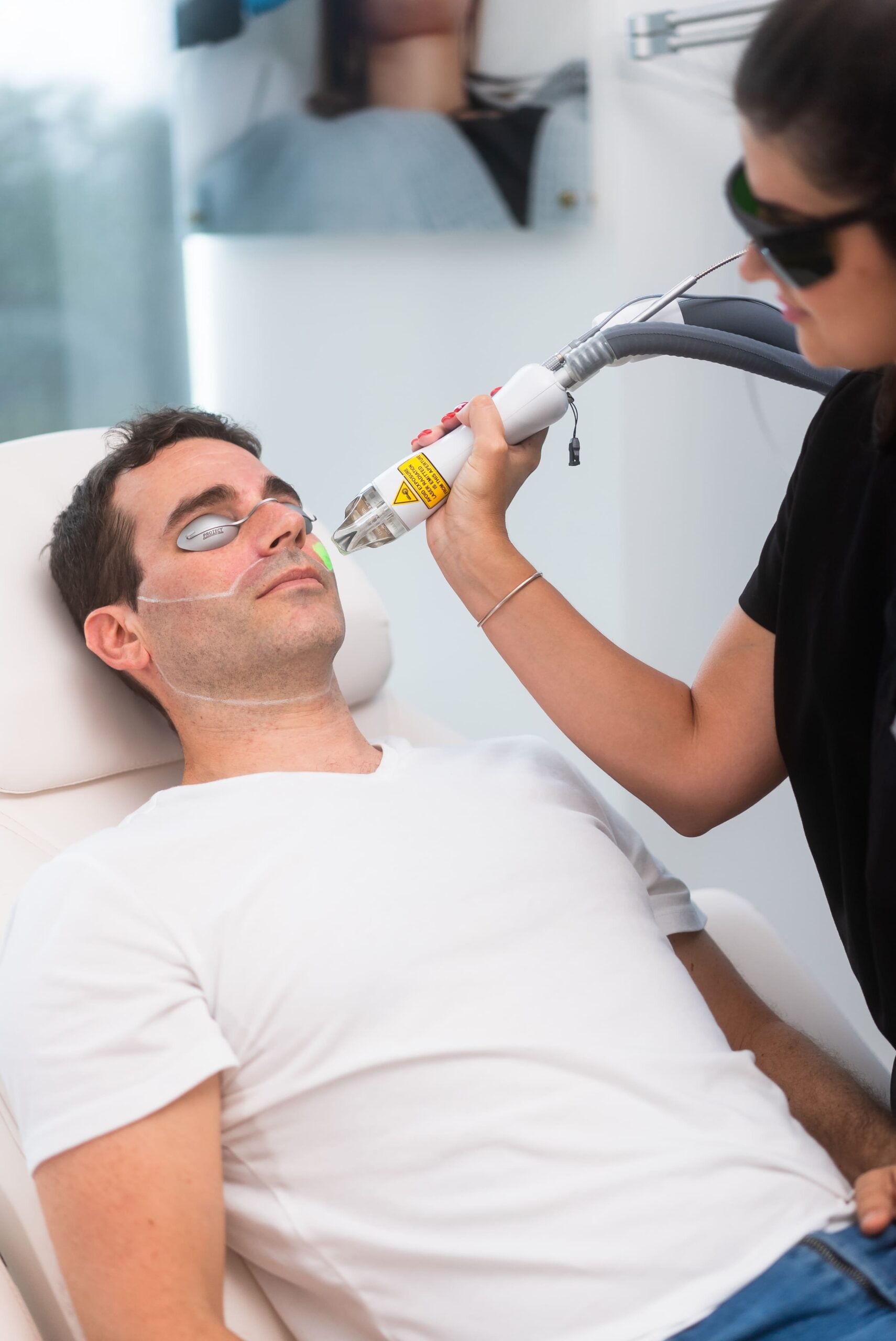 Picture of a man getting laser hair removal treatment for this beard