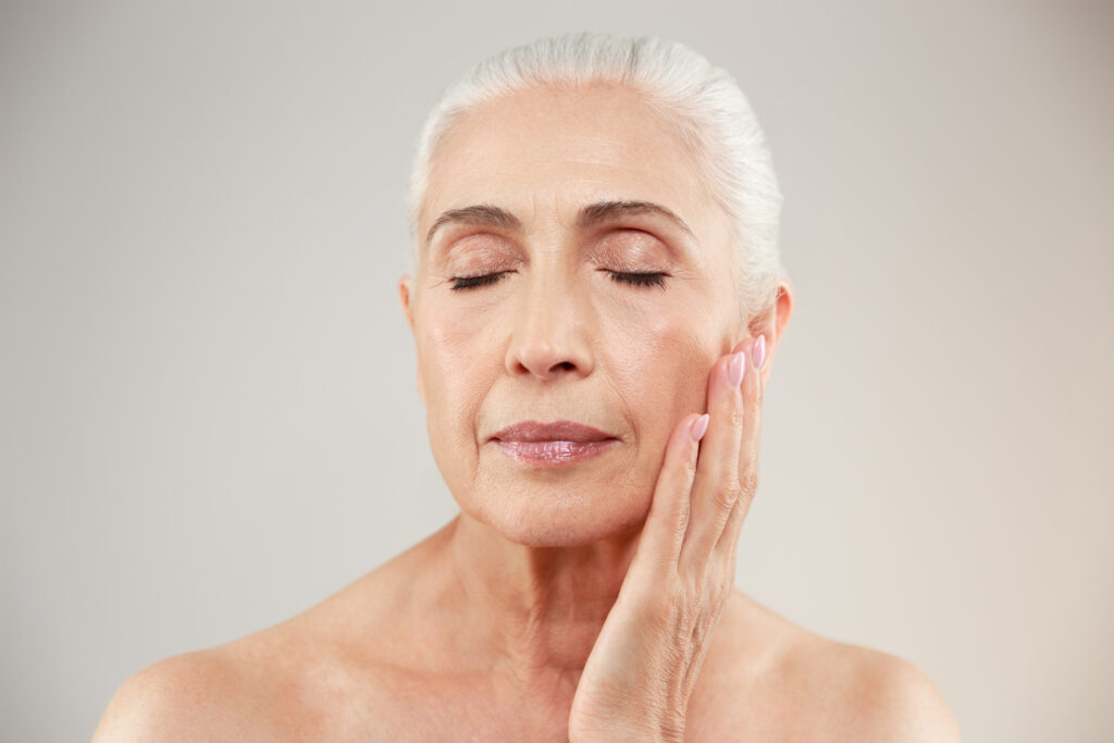 Old women touching the face after getting Sculptra treatment