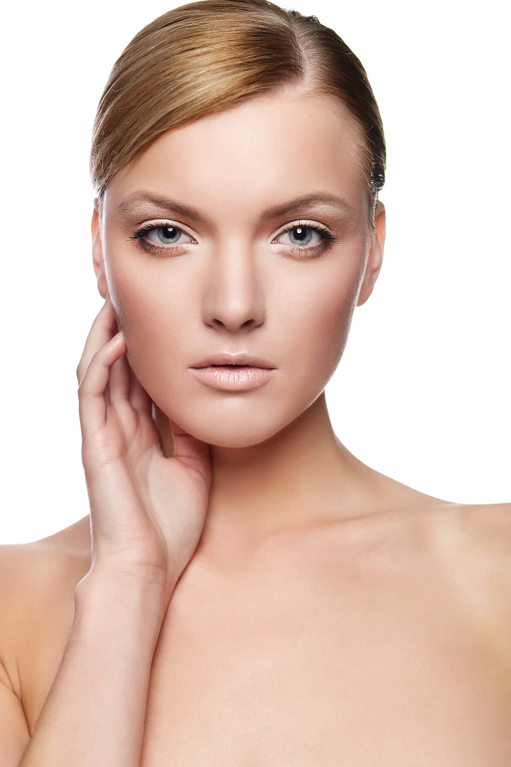 Close-up portrait of a young woman with flawless skin, looking directly at the camera after getting a Photofractional facial.