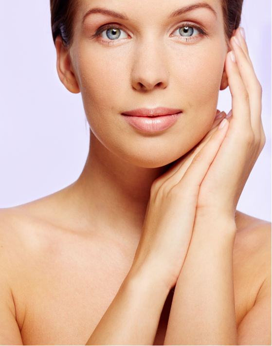 Woman with radiant skin gently touching her face after Erbium glass laser treatment.