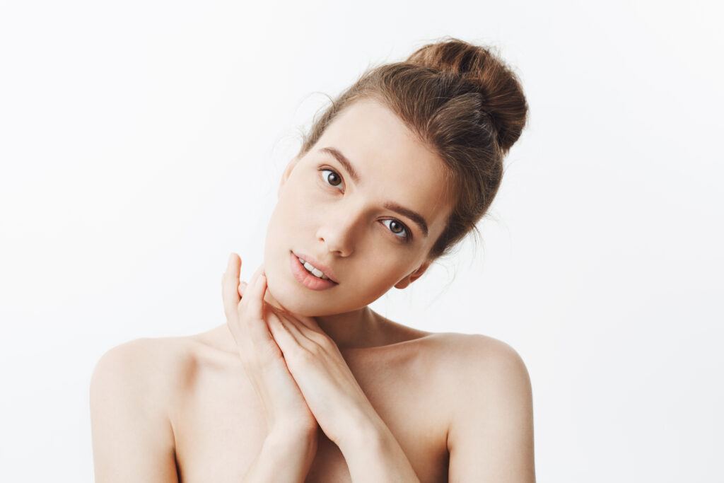 Woman with bun hairstyle and bare shoulders after Hydralight Facial
